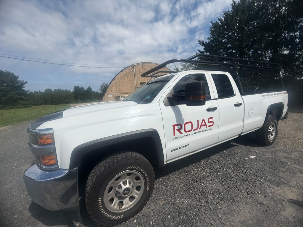ROJAS work truck with ladder rack and company branding